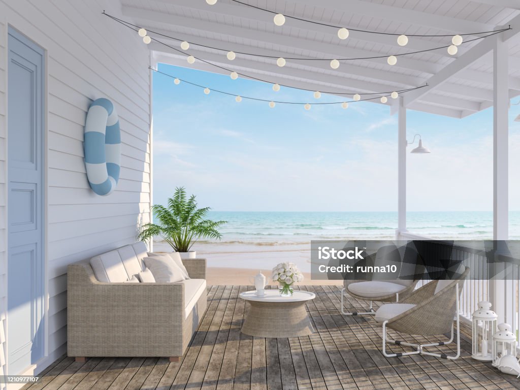 The wooden house terrace on the beach 3d render The wooden house terrace on the beach 3d render,Tthere has old wooden floors,white plank walls,blue doors decorated with fabric and rattan furniture, decorated with string lights, overlooking the sea. Beach Stock Photo