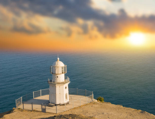 istock lighthouse on a marine cape at the sunset 1210979020