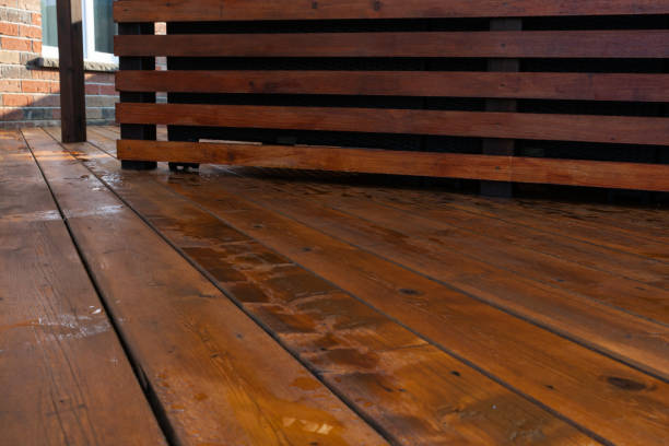 istock Backyard wooden deck floor boards with fresh brown stain, angled view 1210979630
