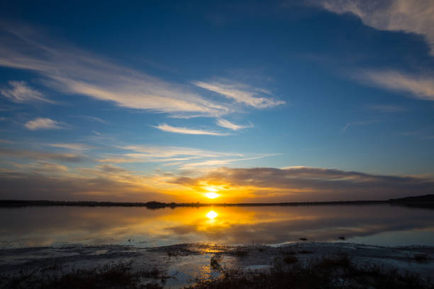 istock dramatic sunset over the quiet lake, evening natural background 1210979781