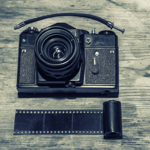 istock Vintage camera on wooden background 1210980379