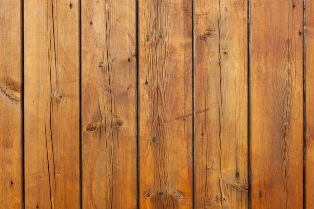 istock Stained wet deck wooden boards with water drops, brown planks texture 1210980476