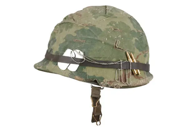 US Army helmet Vietnam war period with camouflage cover goggles and dog tags isolated on white