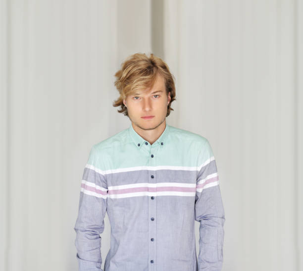 istock Teenager standing near a white wall 1210982309
