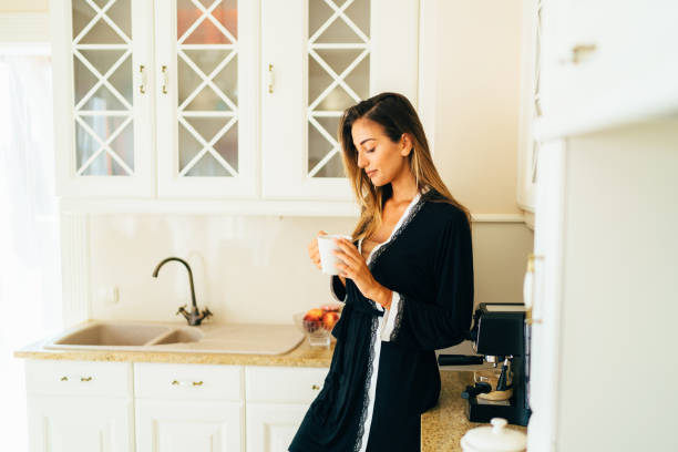 istock Woman drinking coffee in the kitchen 1210983196