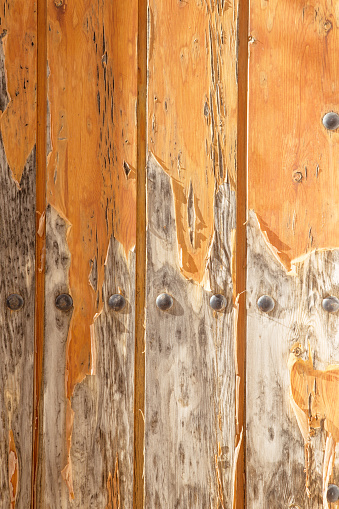 close up detail shot of paint peeling on an old wooden door