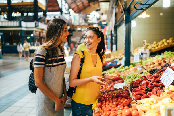 istock Girls buying vegetables 1210983379