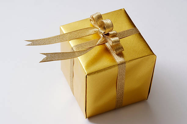 istock Isolated shot of  gold cube gift box on white background 121098347