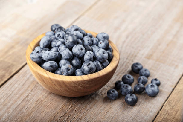 istock Freshly picked blueberries in wooden bowl. Blueberry antioxidant. 1210985115