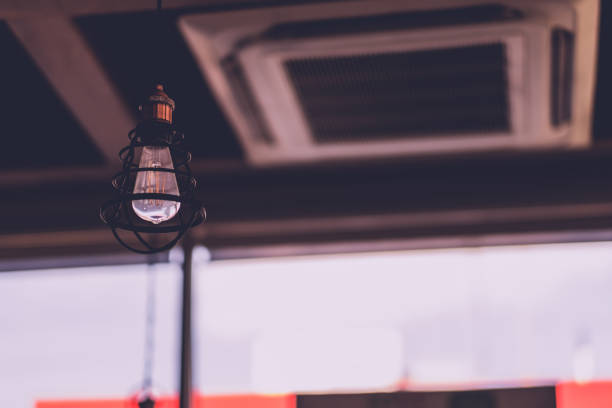 istock Tungsten light bulb Very hanging from the ceiling, vintage tone 1210986026