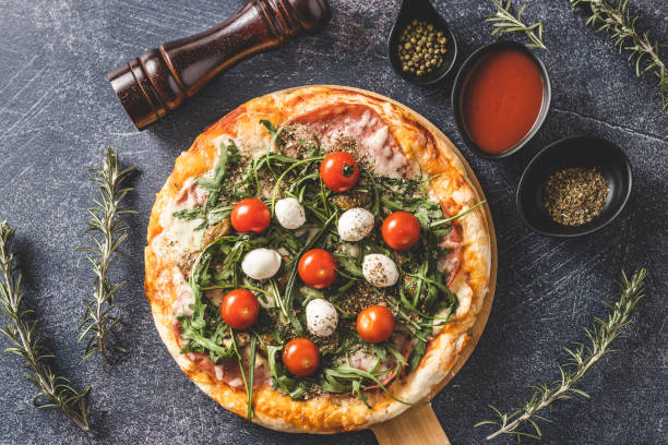istock Delicious pizza with mozzarella, cherry tomato and rocket 1210986108
