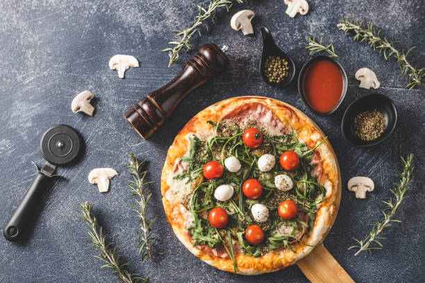 istock Delicious pizza, pizza cutter and pepper shaker 1210986188