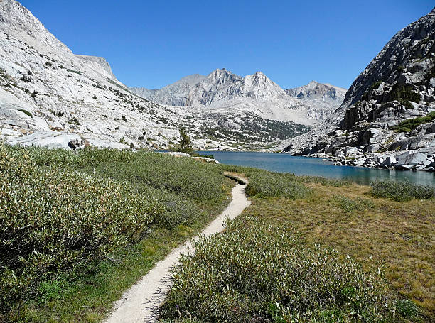 Backpacking Trail Hiking, backpacking trail  in the mountains leading to a glacial lake. pacific crest trail stock pictures, royalty-free photos & images