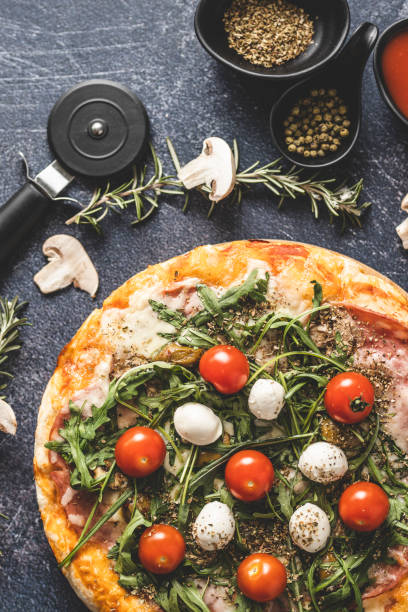 istock Delicious pizza and pizza cutter 1210987188