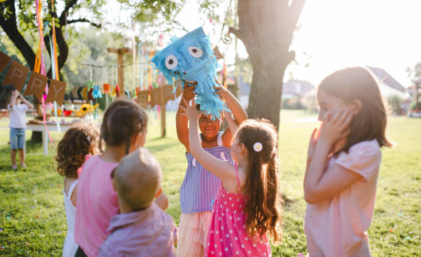 istock Small children with kite outdoors in garden in summer, playing. 1210991646