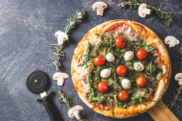 istock Delicious pizza and pizza cutter 1210992150