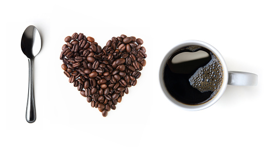 Spoon, coffee beans and coffee cup on a white background, top view