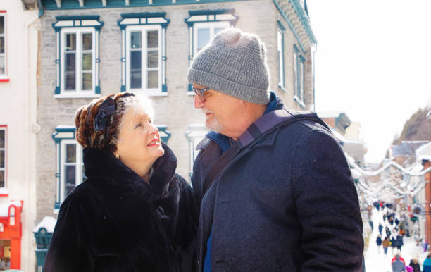 istock Senior Couple smiling at each other while visiting old Quebec City in Winter 1210995106
