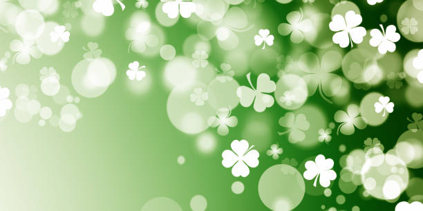 istock St Patrick's day illustration, clover leafs rotating on the green background 1210995135