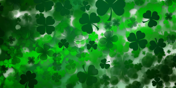 istock St Patrick's day illustration, clover leafs rotating on the green background 1210995140