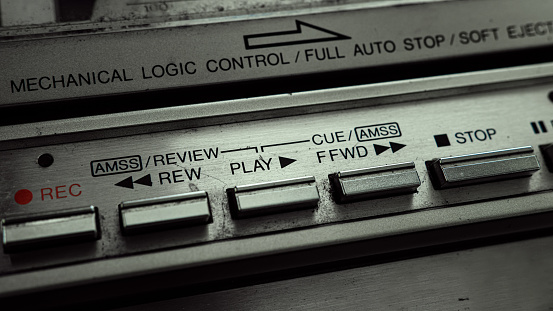 Close up of old cassette player boombox buttons, press the play button. Retro boombox concept.