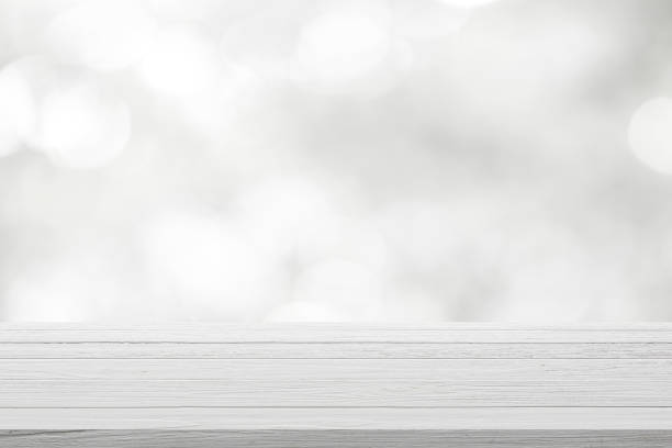 istock Wood table top on white bokeh abstract background. 1211001683