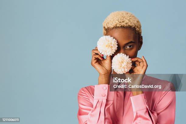 Portrait Of A Beautiful Young Woman Holding Two White Pink Flowers Stock Photo - Download Image Now