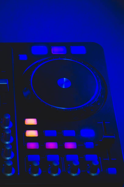 istock Dj sound mixer controller with knobs and sliders. audio mixing deck with turntables at dark with illuminated controls 1211012401