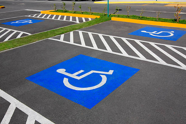 Wheelchair parking space Handicap parking space. Parking lot inaugurated recently. Universal symbols painted on the asphalt. disabled sign stock pictures, royalty-free photos & images