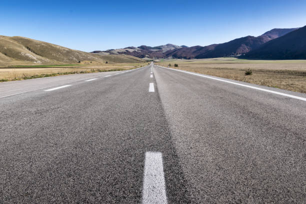 istock Long straight road on asphalt on mountain plateau 1211014561
