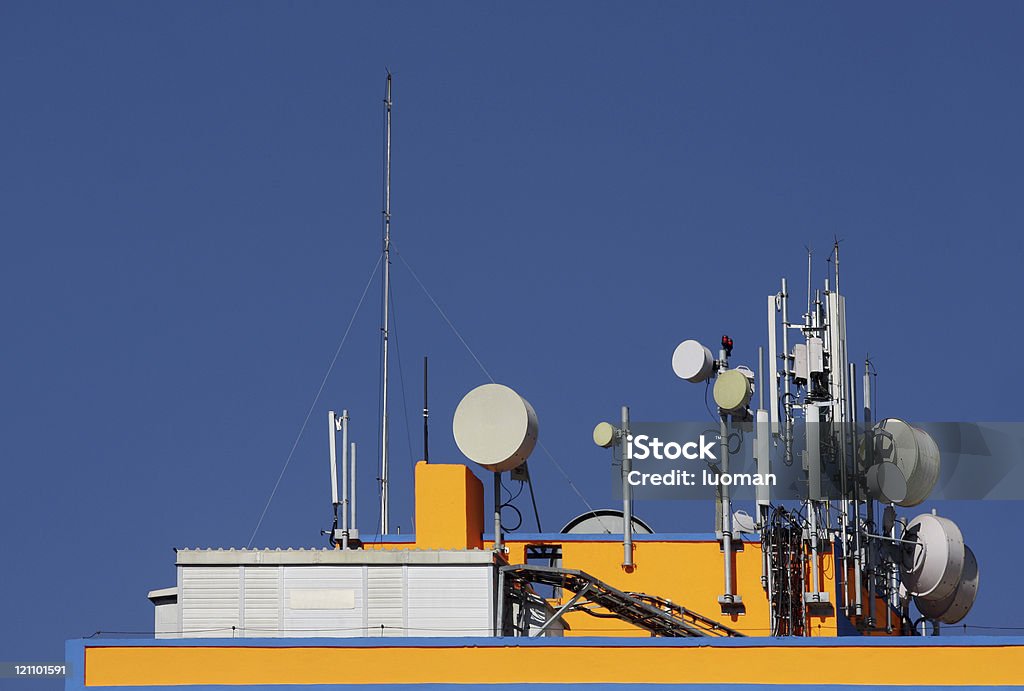 Communication antennas Different communication antennas located at the top of a building Communications Tower Stock Photo