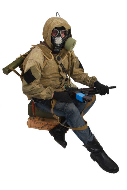 istock Post-apocalyptic fiction concept - stalker in gas mask with weapon and ammunition box. Text on box in russian - type of ammunition and lot number. 1211017342