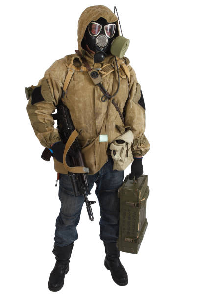 istock Post-apocalyptic fiction concept - stalker in gas mask with weapon and ammunition box. Text on box in russian - type of ammunition (RGD 5 UZRGM - hand grenade) and lot number. 1211017384
