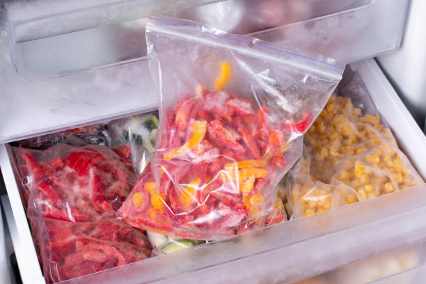 istock Plastic bags with different frozen vegetables in refrigerator, frozen pepper 1211020476