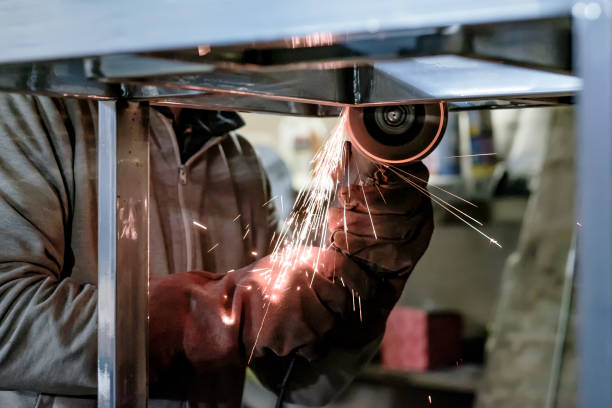 istock Man in protective gloves cutting metal using angle grinder making sparks 1211023864