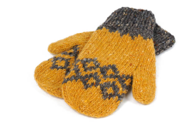 istock Yellow knitted mittens handmade on a white background. Front view. 1211024014