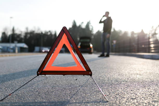 istock Young man calling for help because of a car accident. 1211024190