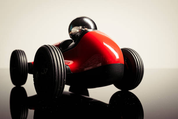 istock Red vintage racing tiny car backwards on a studio shot 1211025175