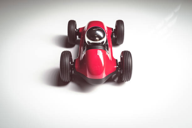 istock Red vintage racing tiny car backwards on a studio shot 1211025183