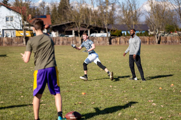 male athletes training american football outdoors - playing field effort outdoors human age imagens e fotografias de stock