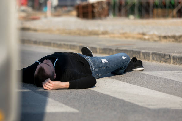 istock Traffic accident. Young man hit by a car 1211025318