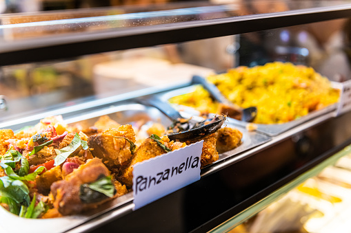 Sign for panzanella Italian traditional soaked bread salad with vegetables in market shop grocery display in Florence Italy closeup buffet tray on counter