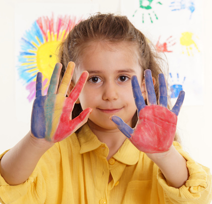 Girl showing colorful painted hands