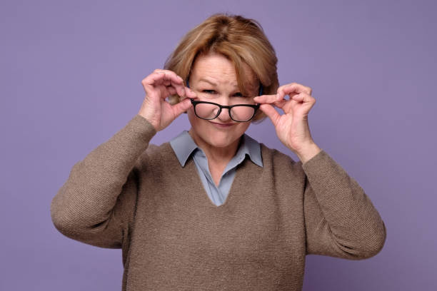 istock Mature attractive woman with glasses looking with intreset at camera. 1211032026