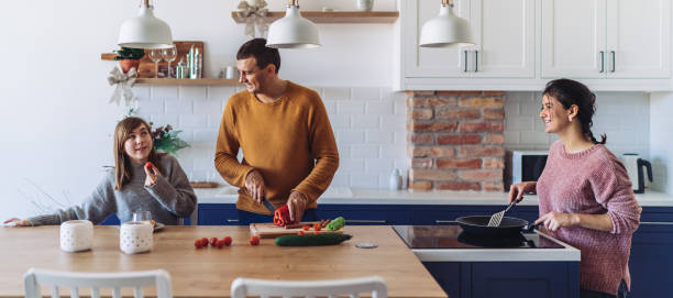istock Mother and father preparing meal for daughter 1211032506