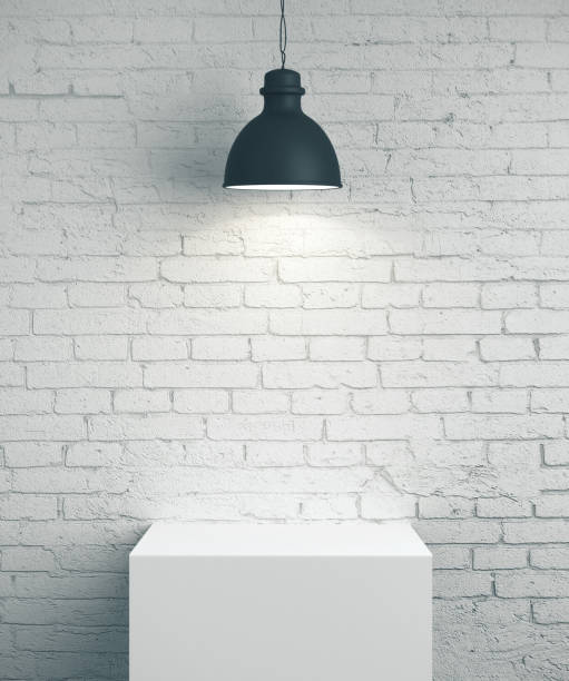 istock Blank brick wall, podium and lamp 1211034932