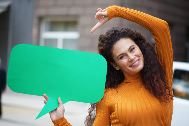 istock Young woman holding a chat bubble 1211036022