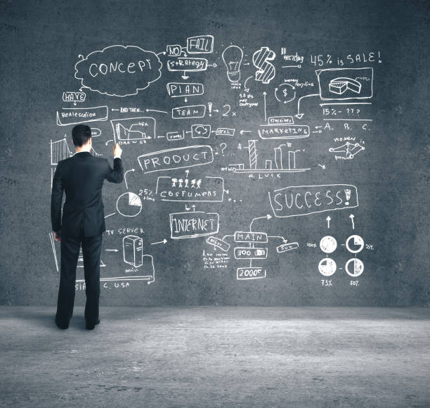 istock Businessman drawing business plan 1211036097