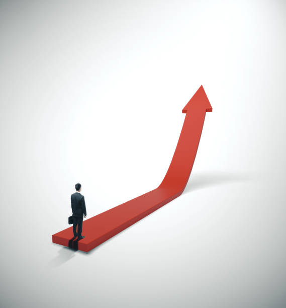 istock Businessman in suit standing on red arrow 1211036170