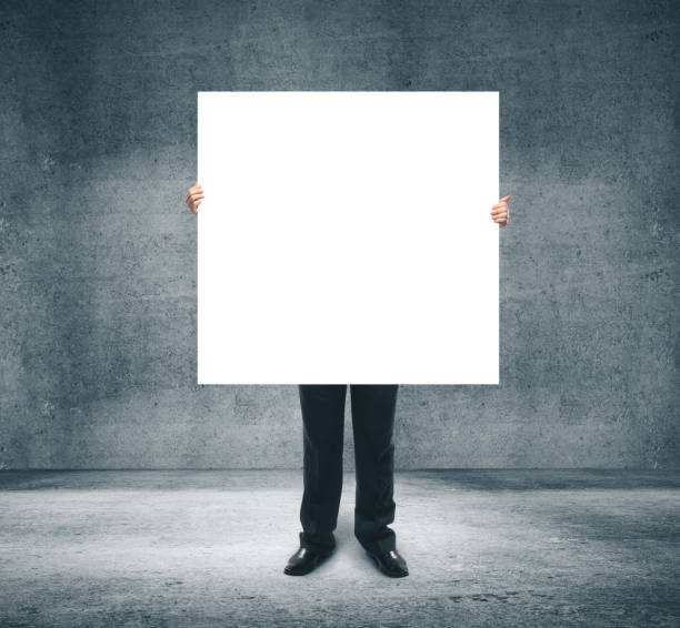 istock Businessman holding blank white billboard 1211036179